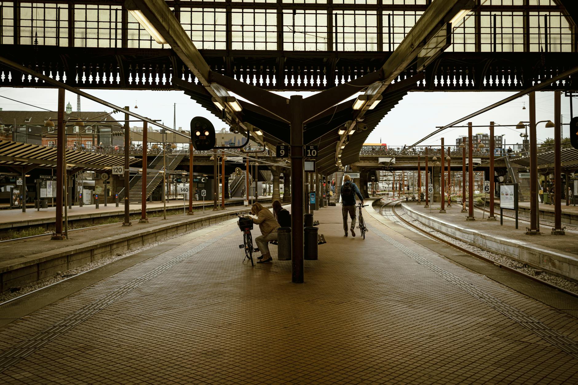 A quiet moment at Copenhagen's railway station, capturing commuters in an urban atmosphere.